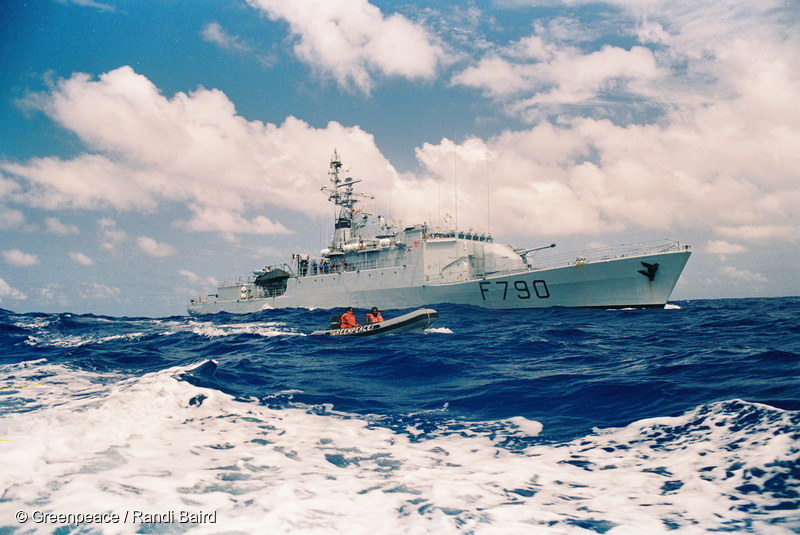 French frigate Lafayette shadowing RAINBOW WARRIOR at the 12 mile  exclusion zone around the French nuclear test site of Moruroa, South  Pacific. Commandoes boarded the RAINBOW WARRIOR after it entered the  nuclear test exclusion zone.  All the crew were removed from the ship.  Most of them were deported - 7 crew members were later allowed back  onto the RAINBOW WARRIOR to sail it to Rarotonga.