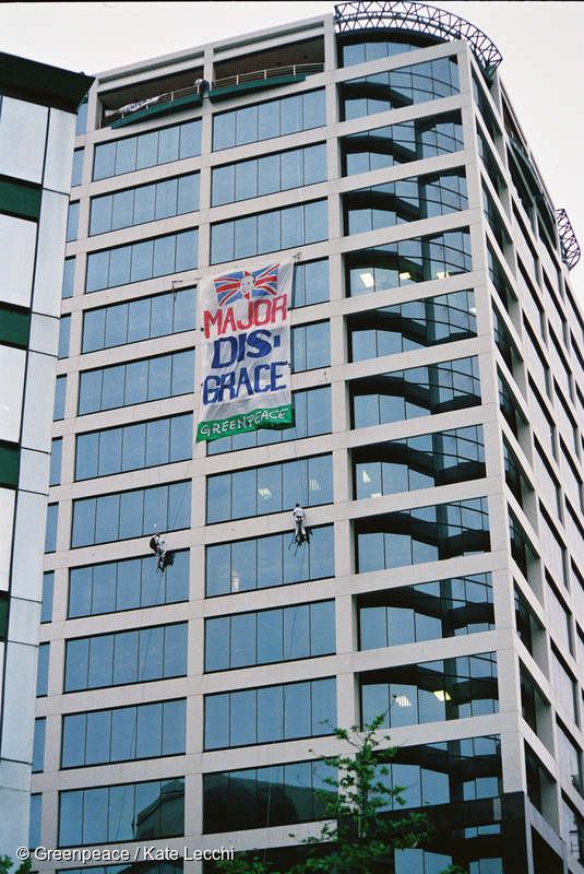 The ‘Major Disgrace’ banner hangs from the AUT Tower opposite the Aotea Square venue of CHOGM