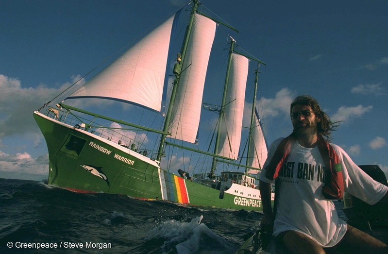 Crew member Alice Leney driving an inflatable boat, seen here flanked by SV Rainbow Warrior II, managed to reach the drill rig and lock himself to it