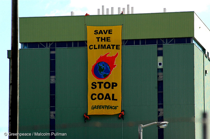 On the day the Kyoto Protocol comes into force, Greenpeace activists hang a banner reading ‘Save the Climate - Stop Coal’ on Marsden B power station. A proposed conversion would change this power station from oil to coal fired which will emit 2 million tonnes of climate changing carbon dioxide each year.
