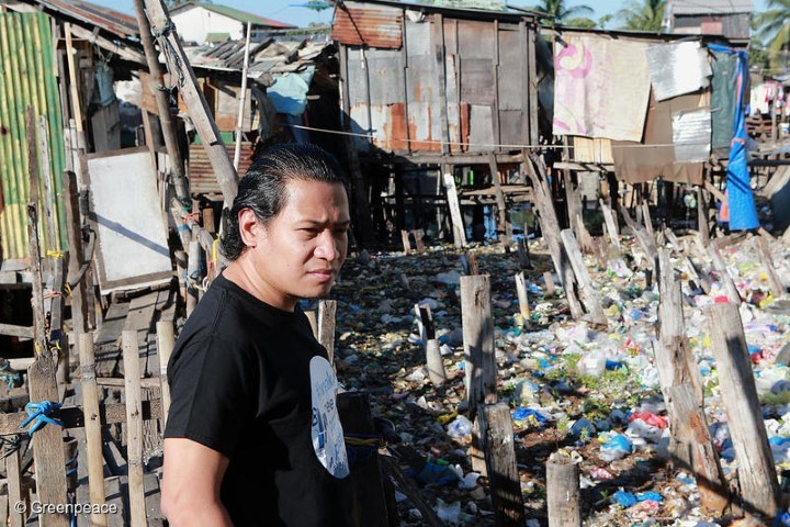 GAIA Philippines Executive Director Froilan Grate stands looks at a trash-filled river where a community of underprivileged residents live in Barangay Bagumbayan North in Navotas City, Philippines.