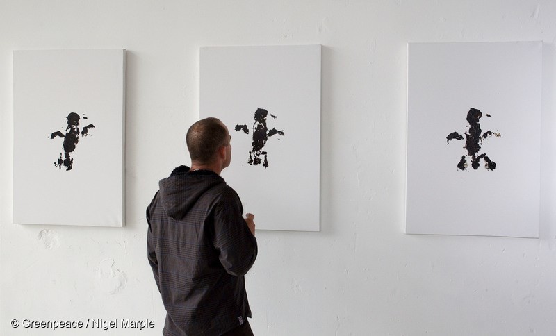 Guests at the Oil on Canvas exhibition at a temporary gallery space at 2 Queen St, Auckland. The images on display were created using two of the estimated 20,000 birds killed by the oil spill that came from the grounded cargo ship the Rena, and a cupful of bunker oil that came from the wreck. While the Rena leaked 350 tonnes of oil, a blowout on a deep sea oil rig, could result in a spill a thousand times worse. Greenpeace NZ is campaigning against the creation of a deep sea oil industry in New Zealand. The exhibition, and creation of the prints, was organised by Greenpeace, in conjunction with the advertising company Publicis Mojo. It is running until Friday December 16.