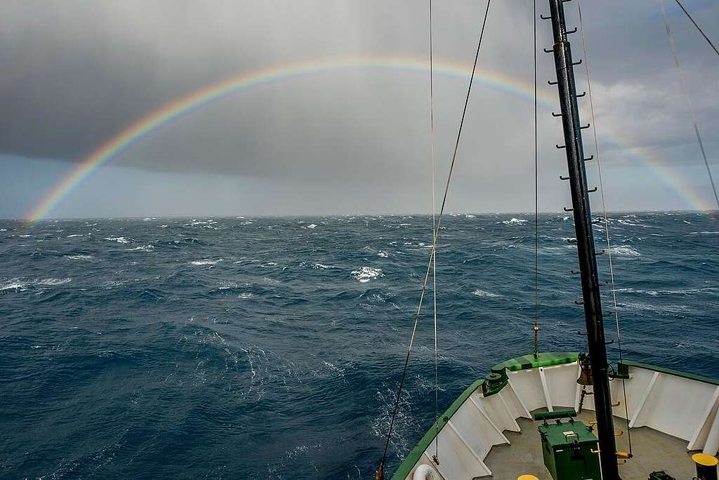 南極德雷克海峽（Drake Passage），向來是惡名昭彰、風高浪急之地，綠色和平船艦極地曙光號去年 1 月聯同美國石溪大學科研團隊調查氣候危機如何影響企鵝生態，卻有幸遇上彩虹映照前方──謹以這張照片寄意，感謝您過去一年與綠色和平並肩守護環境，展望 2023 年繼續逆流中前行，綠色和平與您攜手航向可持續未來。 © Tomás Munita / Greenpeace