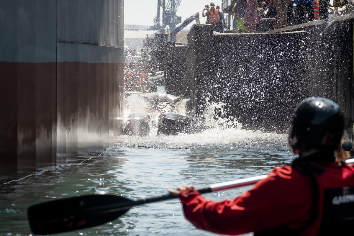 A Greenepace's inflatable boat crushed by the freighter. © Simon Lambert / Greenpeace