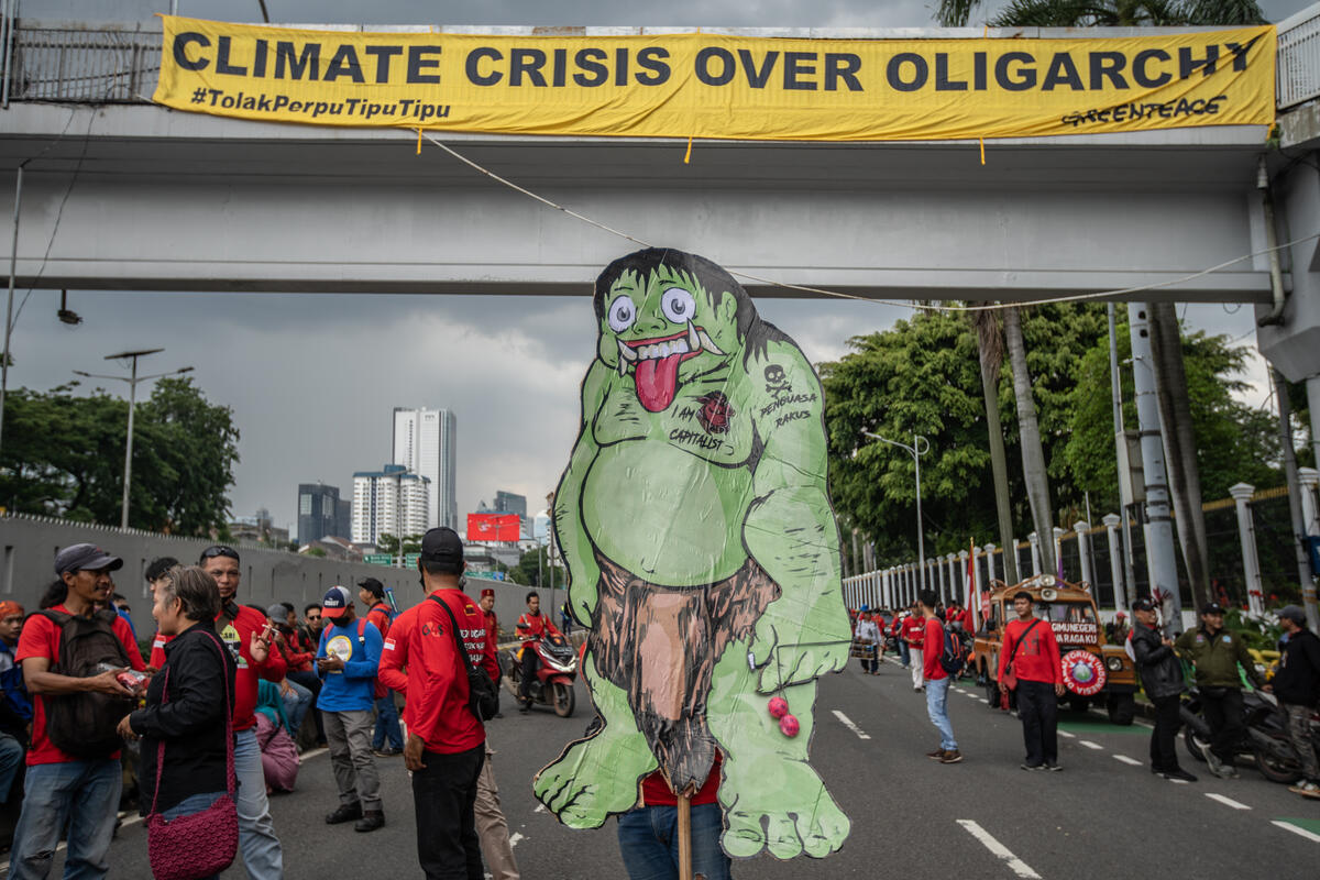 Omnibus Law Bill Protest in Jakarta A worker carries a sign with a monster symbolizing the Oligarchy during a joint coalition protest against the controversial Omnibus Law bill on job creation (RUU Cipta Kerja) in Jakarta.
Greenpeace Indonesia join the activity and display a banner reading "Climate Crisis Over Oligarchy".