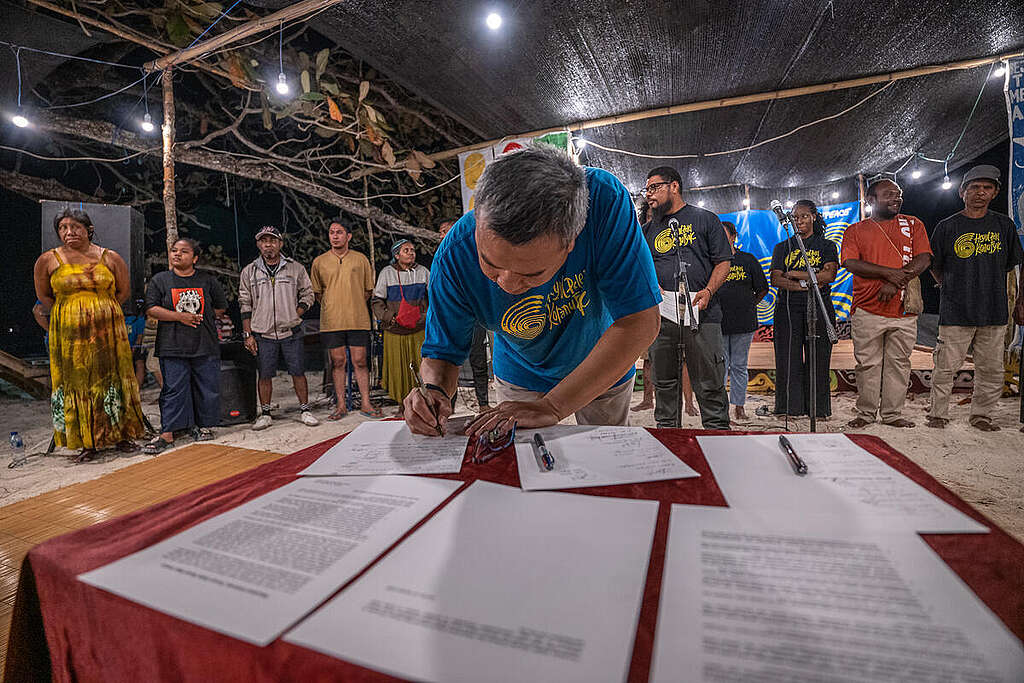 Raja Ampat Indigenous Peoples Gathering NGO representative from Greenpeace Indonesia, Kiki Taufik Isigns the Declaration of Arborek together with Indigenous people of Papua, Amazob Brazil, Cameroon, and Malaysia during the Raja Ampat Indigenous Grand Assembly in Arborek island, Raja Ampat, Southwest Papua. To celebrate the International Day of the World’s Indigenous Peoples, and to support their movement to protect their lans, Greenpeace and USBA hold a series of events at Arborek island in Raja Ampat, Southwest Papua. This is also a follow-up to the #SaveRajaAmpat campaign and the Indigenous Senate Assembly, which resulted in eight main demands, This meeting is also a step towards CBD COP - 17 in Armenia.