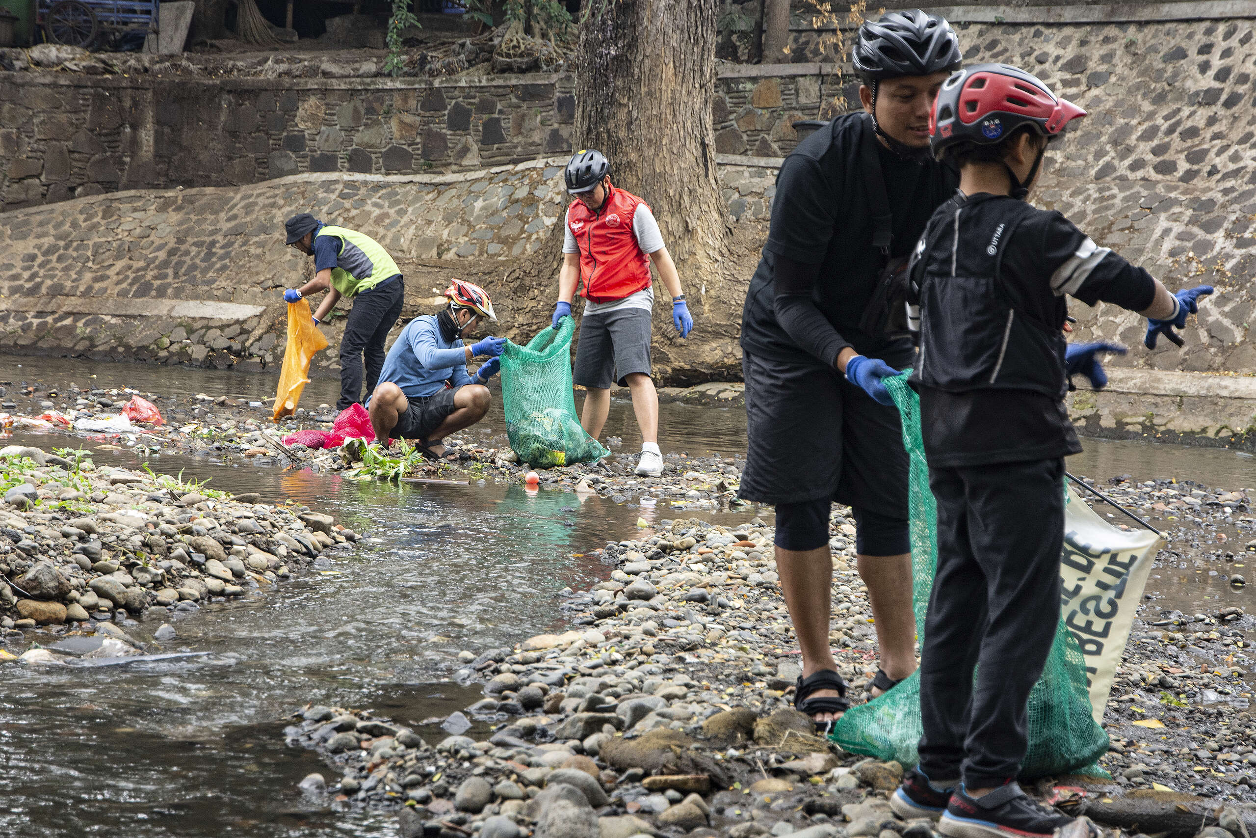 Biking to Plastic Free Parade Picnic in Bandung Bikers participates in a cleanup action on Cikapundung riverside during Bike Tour enroute to Plastic Free Parade picnic in Bandung.