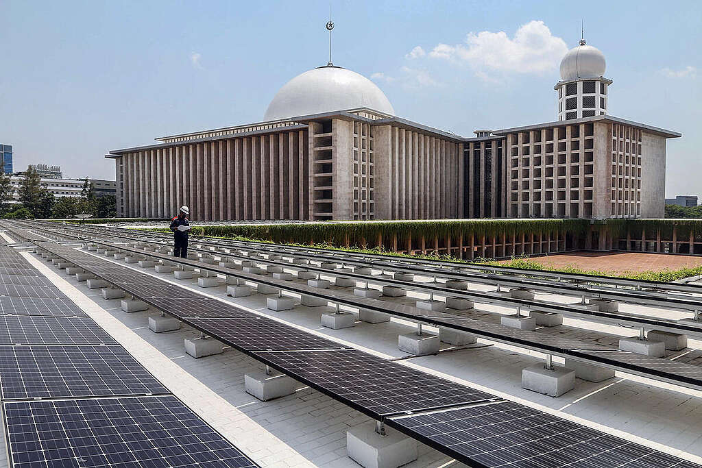 A technician inspects solar panels on the roof of Istiqlal grand mosque in Jakarta.