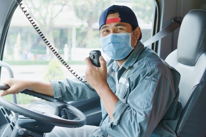 Public transport worker wearing a face mask and working during the Covid crisis in Bangkok, Thailand.