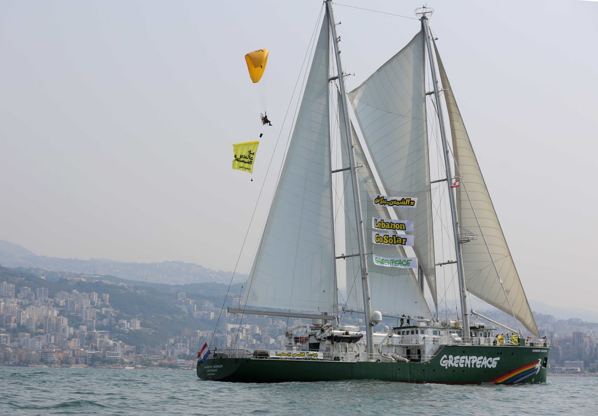 Paraglider Banner Action over Rainbow Warrior in Lebanon © Imad Maalouf / Greenpeace