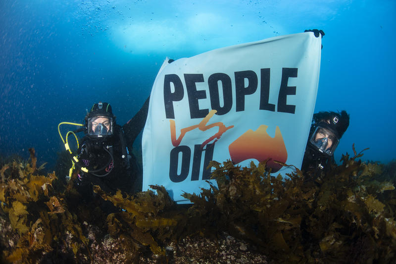 Two divers with a People Vs Oil banner underwater in the Great Australian Bight