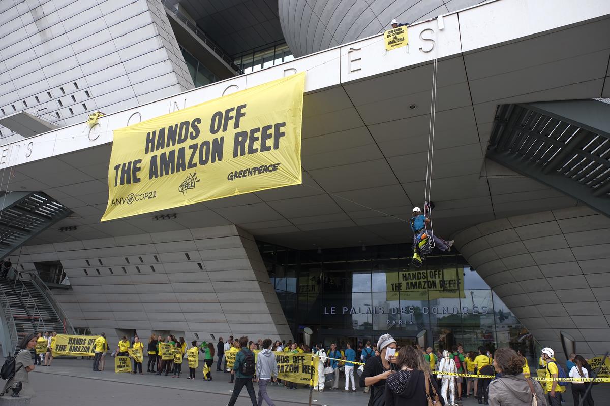 Activists protest against oil drilling in the Amazon Reef during Action at Total’s AGM in Paris. © Simon Lambert