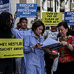 Ms. Christine Ponce Garcia, Corporate Affairs Executive of Nestle Philippines (Middle) receives a demand letter and “invoice from the Filipino people” outlining the costs of Nestlé’s single-use plastic packaging 