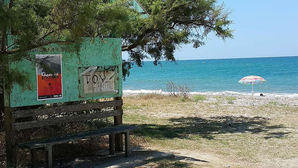 Activists reclaim public space in Preveza, Greece with climate emergency “advertisements”. © Greenpeace