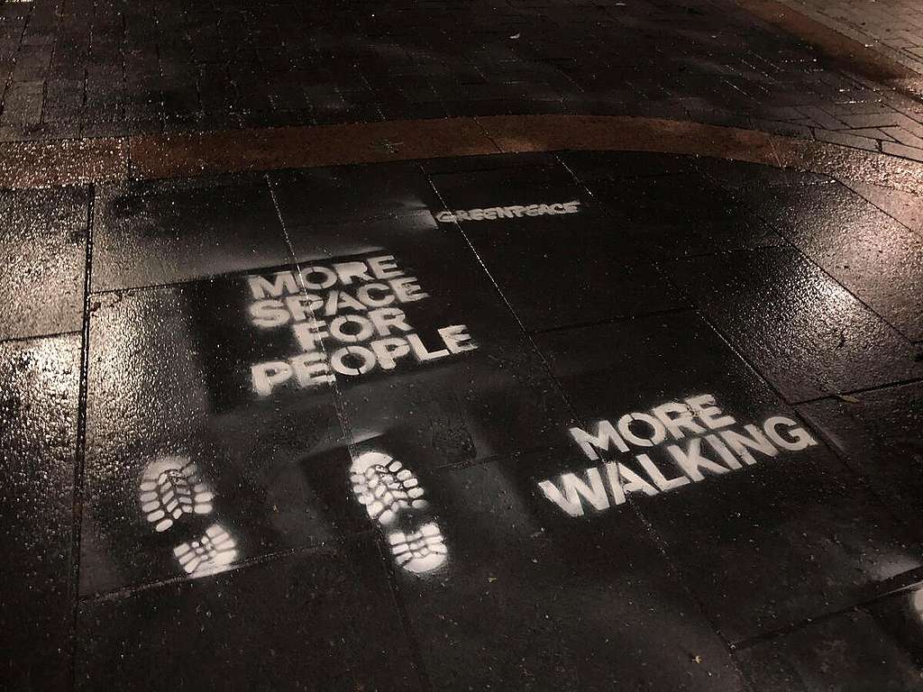 Greenpeace volunteers in Derby spray green recovery messages. © Greenpeace Greenpeace volunteers in Derby spray green recovery messages. "More space for people" ; "more walking". © Greenpeace