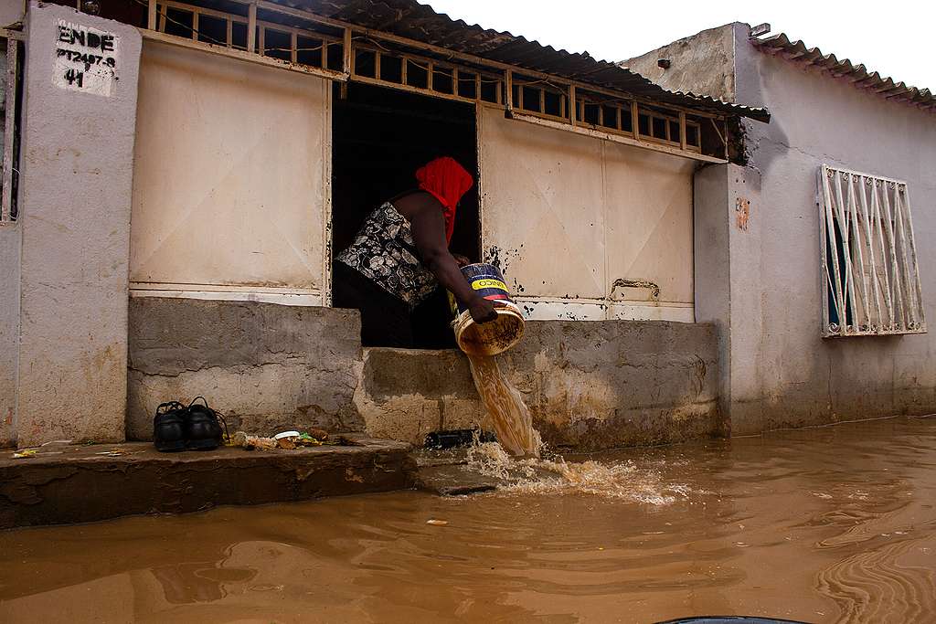 A resident throws out floodwater from her house in the Futungo District in Luanda, Angola. © OSVALDO SILVA/AFP via Getty Images ANGOLA-FLOOD, OSVALDO SILVA/AFP via Getty Images