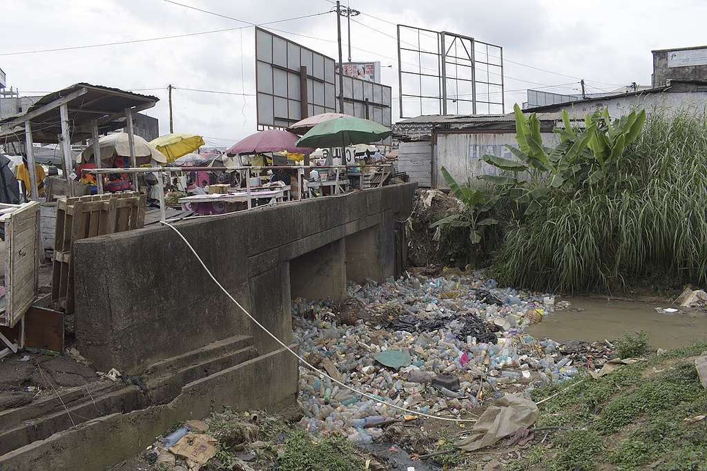 Plastic pollution completely clogging up a stream under a bridge in Dakar neighborhood in Douala, Cameroon © Greenpeace Africa. © Greenpeace Africa Plastic pollution completely clogging up a stream under a bridge in Dakar neighborhood in Douala, Cameroon © Greenpeace Africa