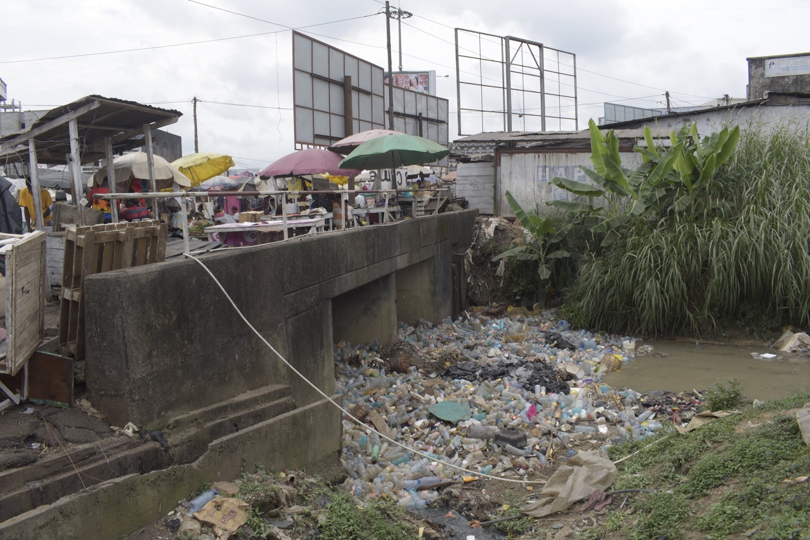 Plastic pollution completely clogging up a stream under a bridge in Dakar neighborhood in Douala, Cameroon. © Greenpeace Africa