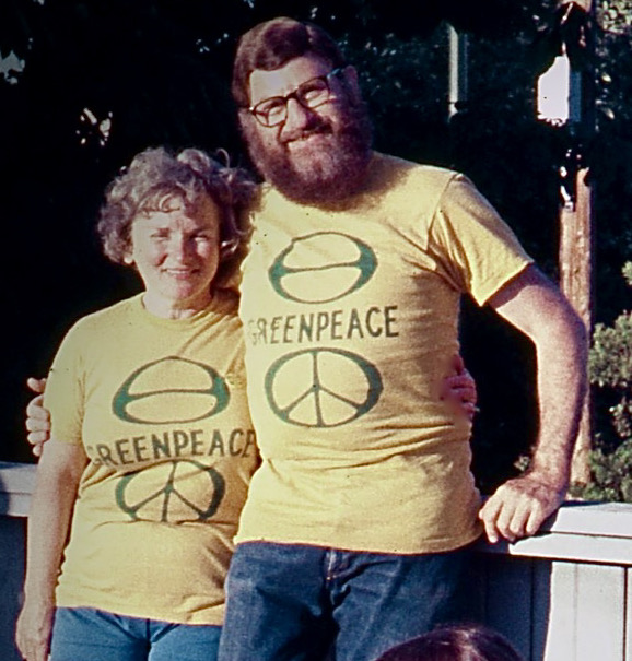 Dorothy and Irving Stowe standing together wearing Greenpeace T-shirts in 1971.