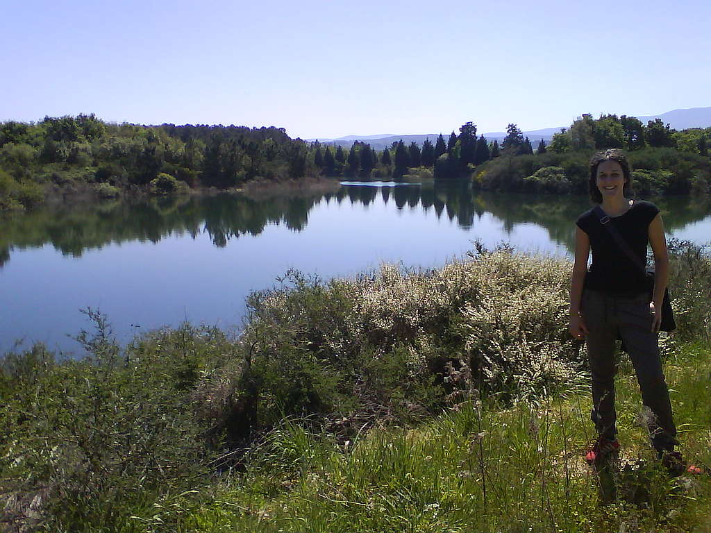 Montse Valencia León (Concello de Lobeira, Baixa Limia, Ourense, Galicia) stands on the grass next to a lake where she lives in Spain.
