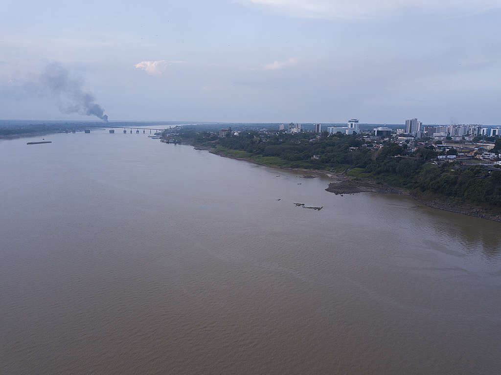 A fire hotspot can be seen in the distance, near the city of Porto Velho