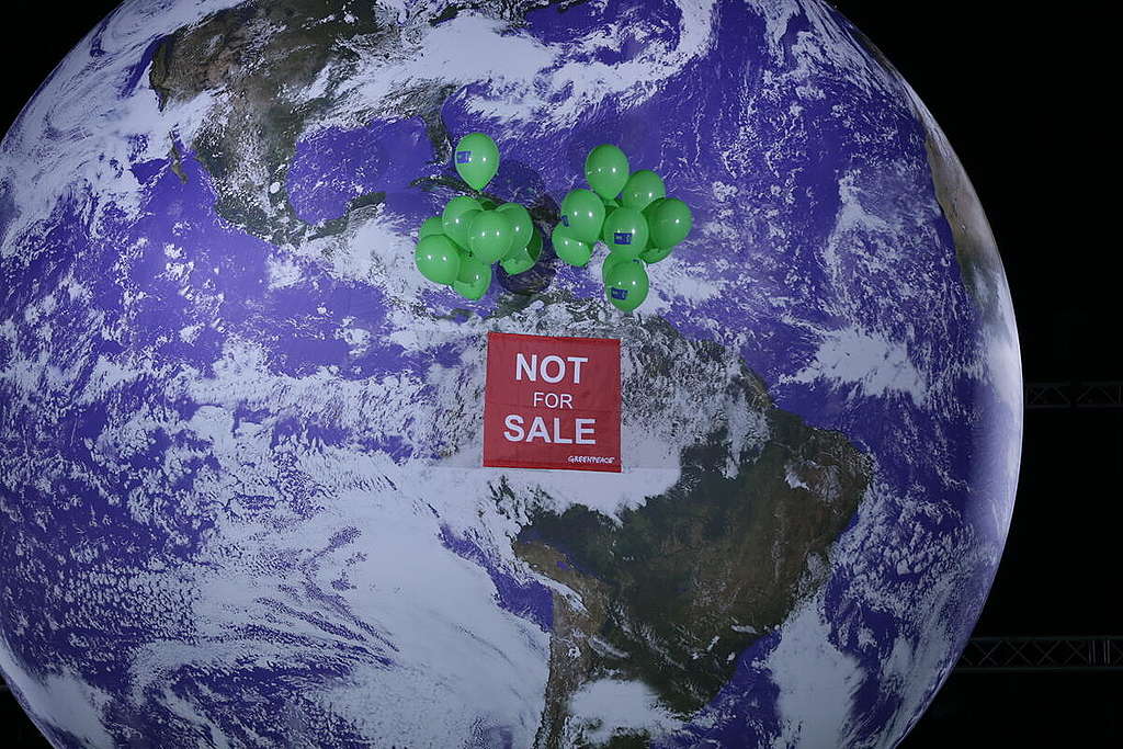 "Not For Sale" Banner on Iconic Giant Globe at COP26 in Glasgow. © Emily Macinnes / Greenpeace