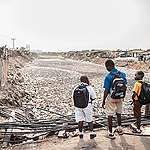 School children in Ghana look over plastic waste