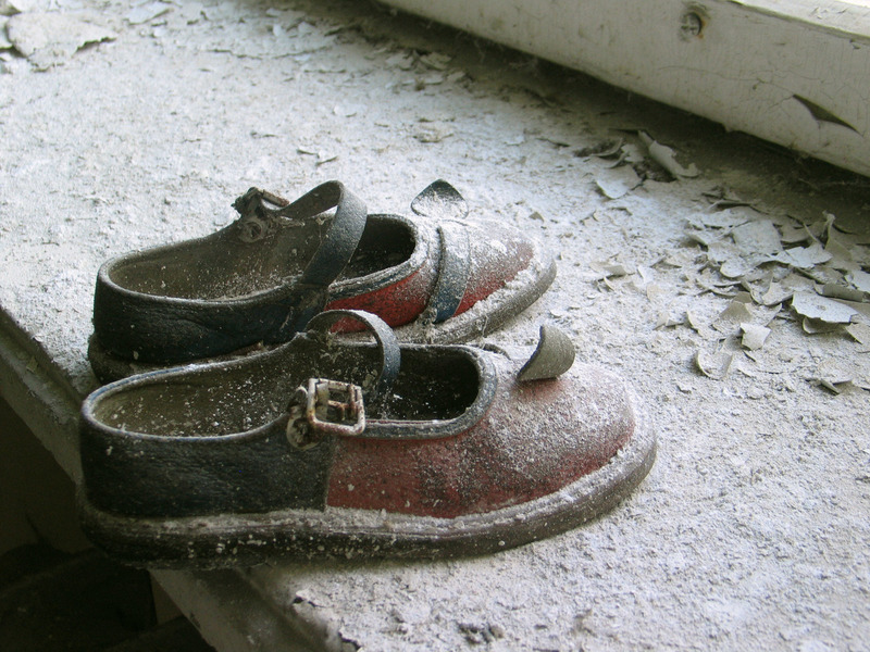 Abandoned baby shoes in a Pripyat kindergarten.