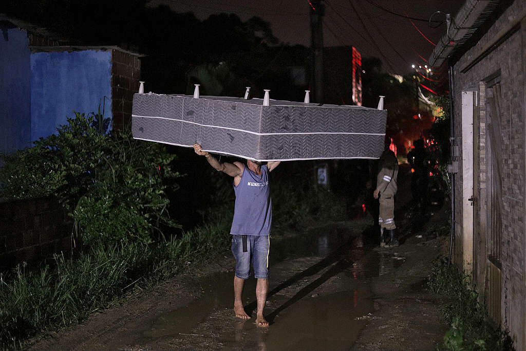 On May 31, 2022. A man carries a mattress after a landslide in the community Vila dos Milagres in Recife, Pernambuco State, Brazil,  Flooding and landslides triggered by torrential rain have now killed at least 106 people in northeastern Brazil.  SERGIO MARANHAO/AFP via Getty Images)