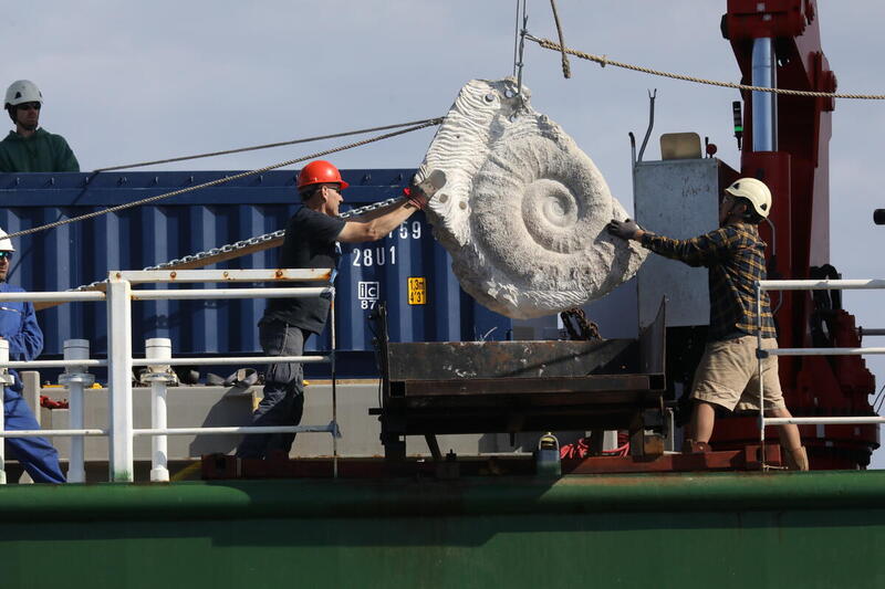 The Ammonite boulder is placed in the sea. Greenpeace UK place 18 limestone boulders on the seabed in the South West Deeps Marine Protected Area to block destructive industrial fishing. Campaigners and crew on board Greenpeace ship Arctic Sunrise sail to the western English Channel to make a portion of the South West Deeps off-limits to bottom-trawling. © Kristian Buus / Greenpeace