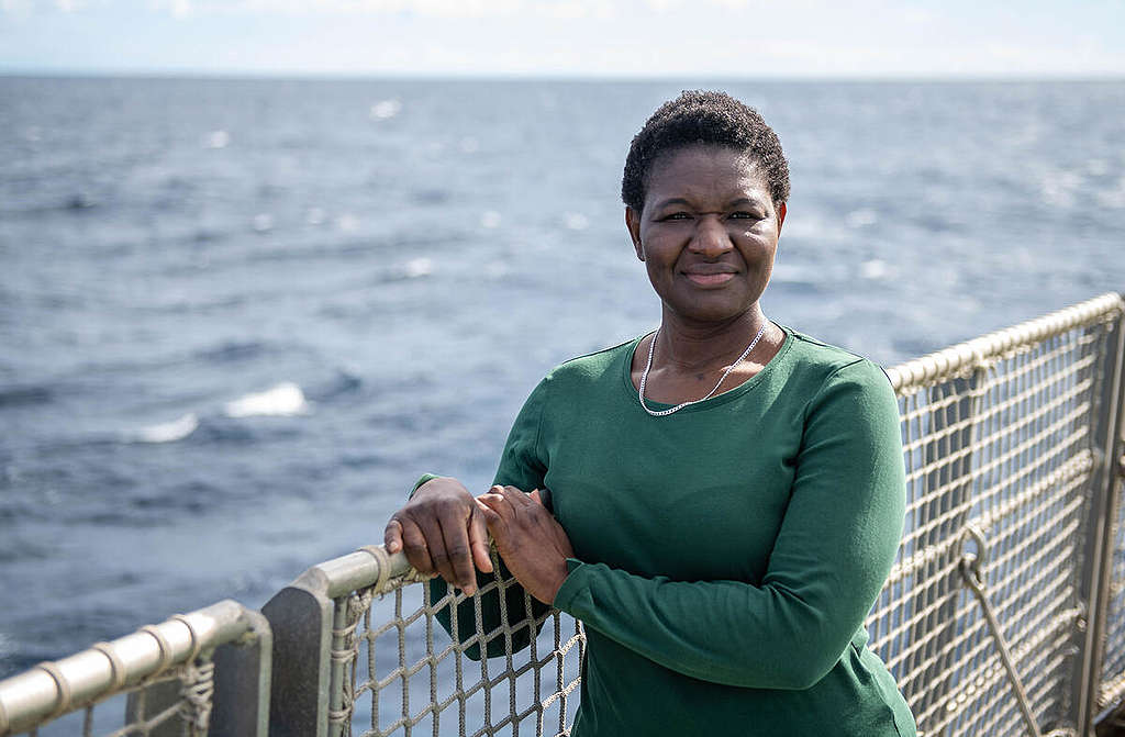 Portrait of Victorine Che Thöner on board the Greenpeace ship Arctic Sunrise, wearing a green top