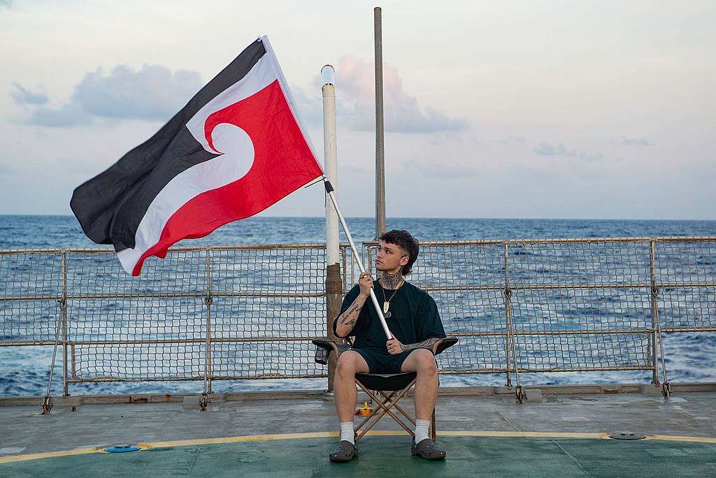Pacific activist Quack Pirihi with the Tino Rangatiratanga flag, also known as the national Māori flag, onboard the Arctic Sunrise heading to the ISA in Jamaica. © Martin Katz / Greenpeace