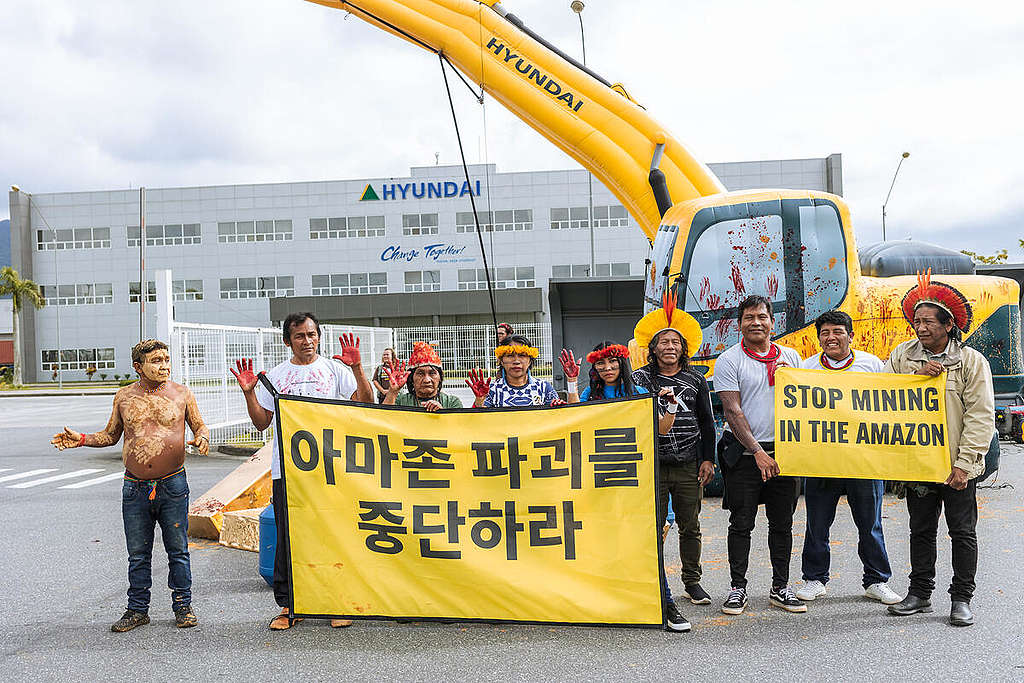 Indigenous Leaders and Greenpeace Brazil activists demonstrate in front of Hyundai Construction Equipment's factory in Rio de Janeiro, Brazil