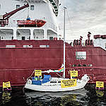 18th June, Mongstad, Norway – Activists from Greenpeace Nordic have taken peaceful action against a tanker, carrying toxic waste from the Norwegian oil industry to be discharged in Denmark. The activists have attached a small sailboat to the hull of the tanker BOTHNI that is transporting up to 9000 tonnes of toxic wastewater from Norwegian oil giant Equinor’s refinery at Mongstad. As much as 150 000 tonnes of toxic water is believed to be exported to Denmark each year where it is treated before being released into Danish waters. The current treatment is unable to remove harmful toxic and carcinogenic chemicals such as PFOS and PAHs from the water, and local people have reported a dramatic decline in fish populations in areas where the water is discharged., Greenpeace block Equinor’s illegal toxic waste export