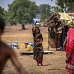 People fill their buckets from a municipal water tanker on May 20, 2022, in Lahuriya village, 65 kms (40 miles) from Mirzapur, Uttar Pradesh, India. A severe heatwave has caused drought-like conditions in vast swathes of India's agricultural heartlands from north to south. India is particularly vulnerable to drought as its agriculture sector is heavily dependent on timely, uninterrupted natural weather cycles for its survival.  Ritesh Shukla/Getty Images