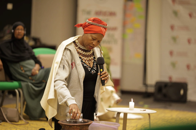 A participant from Mozambique performing water ritual - Surfacing intentions for the AFACJ week