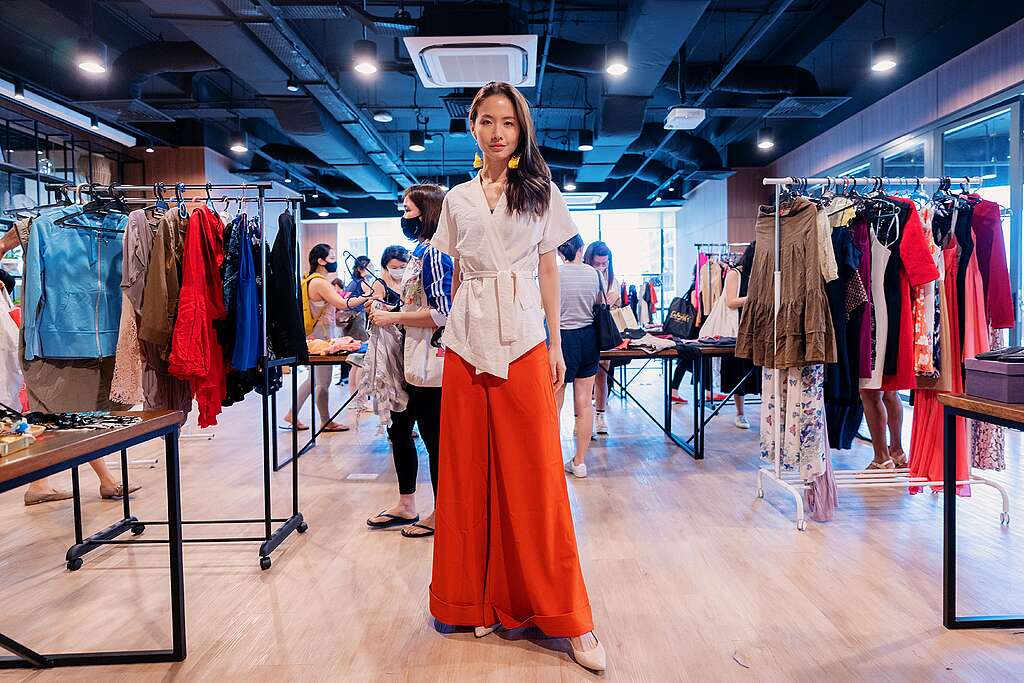 A woman standing inside a clothes swap meets store