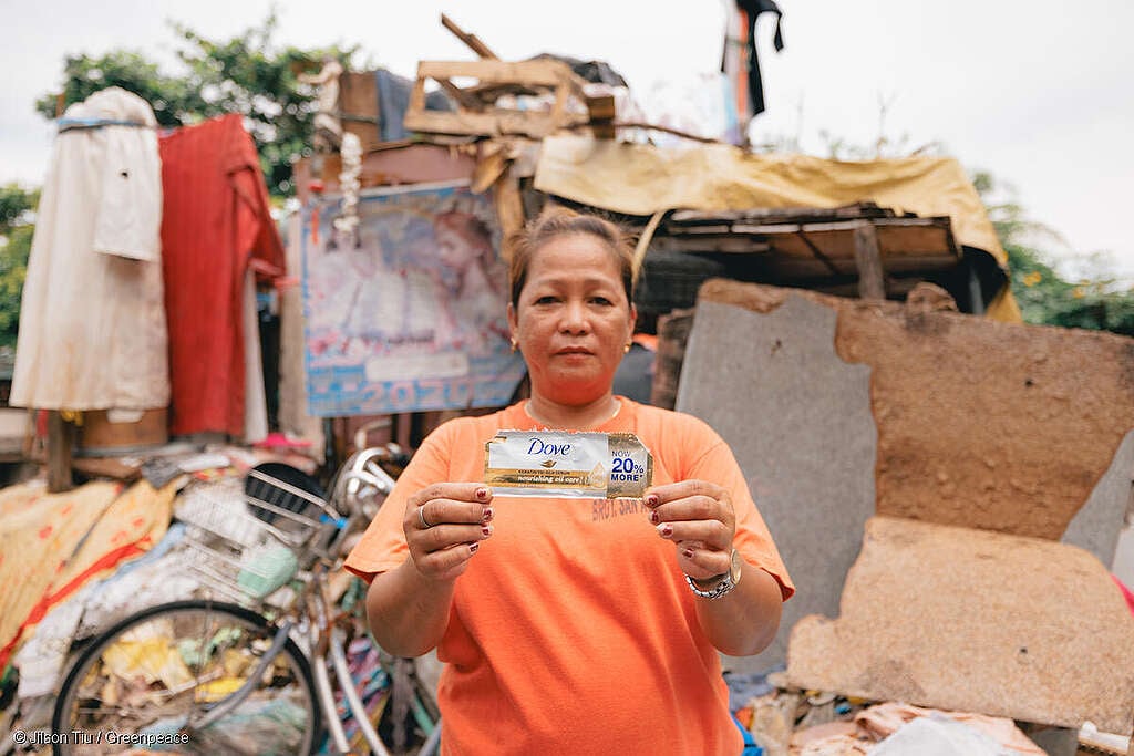 Plastic Waste Investigation in the PhilippinesA street sweeper and waste worker Marilou Manangat, a mother of 4, who lives by the river dumpsite and oil factory holds a Dove sachet packaging by her place as she uses the shampoo personally.