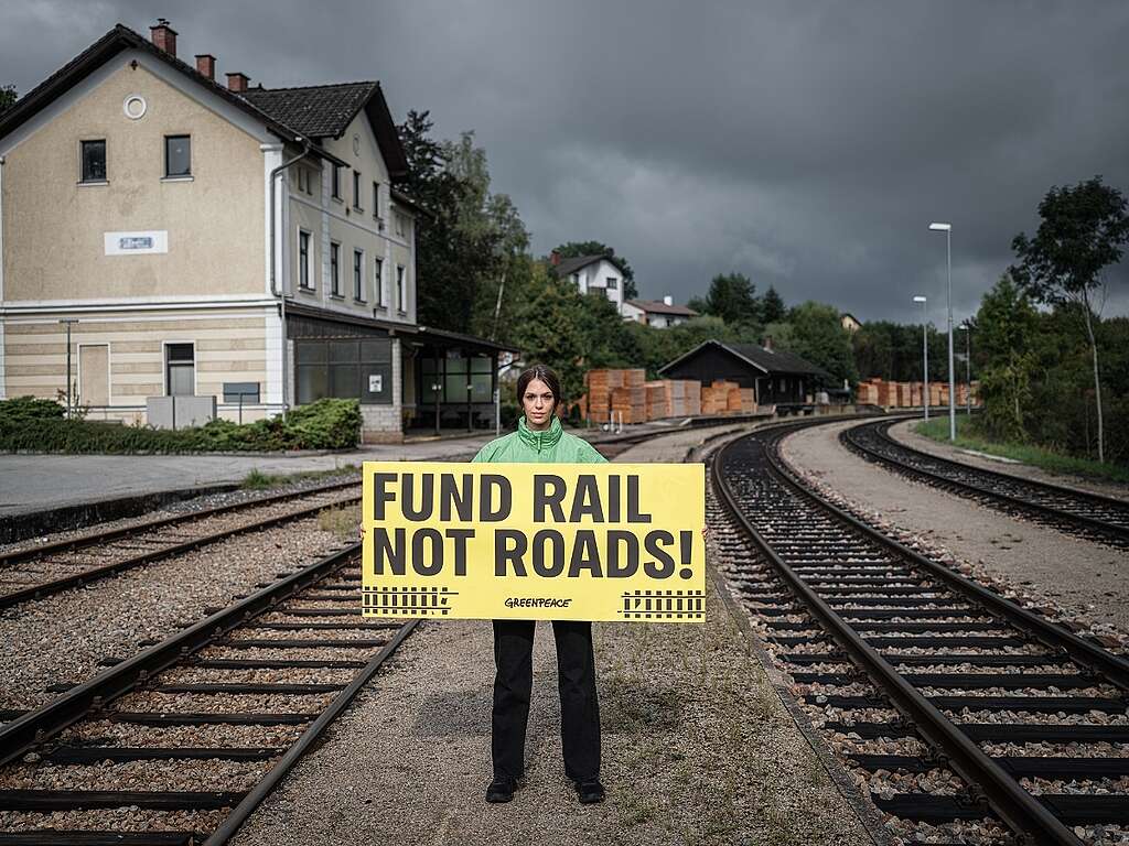 Greenpeace Austria hols a banner saying 