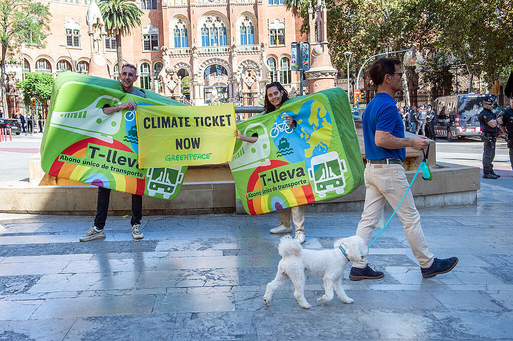 Greenpeace Spain holds up a banner to European transport ministers meeting in Barcelona saying 