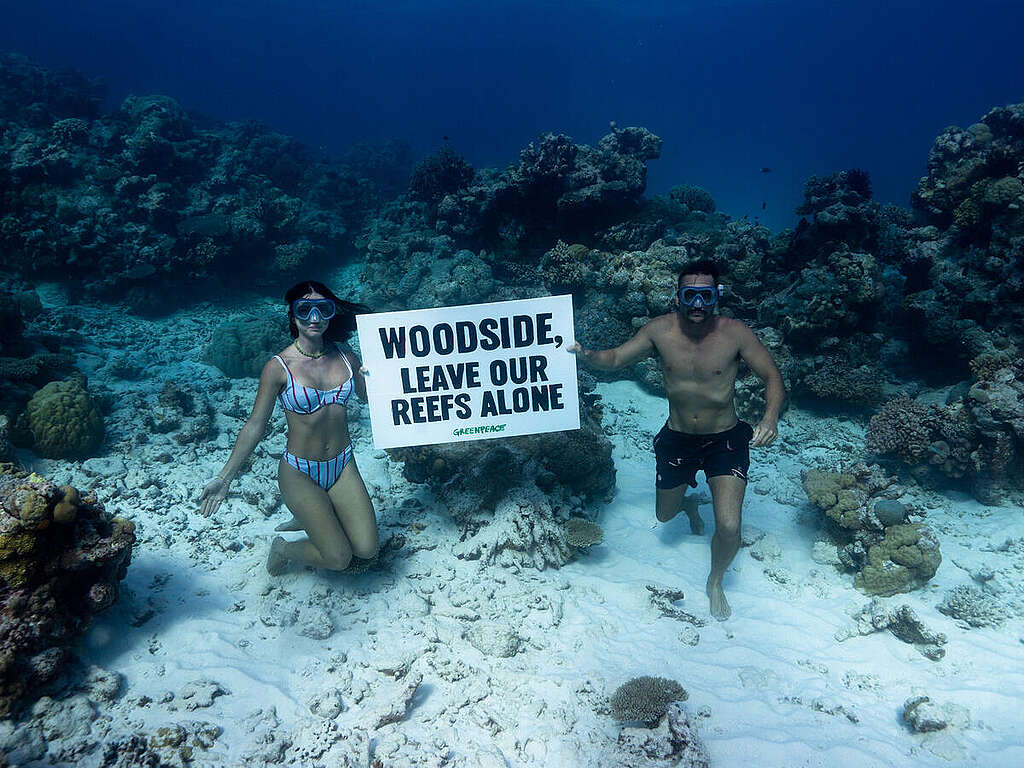 Influencers Riley Whitelum and Elayna Carausu, from Sailing La Vagabonde, hold a sign reading 
