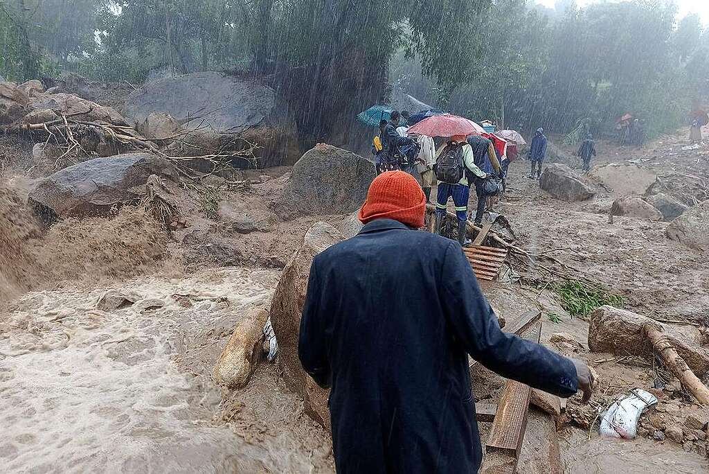 People walk across a makeshift bridge over flood water in Blantyre on March 14, 2023, caused by heavy rains following cyclone Freddy's landfall. - Cyclone Freddy, packing powerful winds and torrential rain, killed more than 100 people in Malawi and Mozambique on its return to southern Africa's mainland, authorities said on March 13, 2023.
Freddy, on track to become the longest-lasting storm on record, barrelled through southern Africa at the weekend for the second time within a few weeks, making a comeback after a first hit in late February. © JACK MCBRAMS / AFP via Getty Images