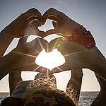 Greenpeace Esperanza crew members form hearts with their hands to say 'Goodbye and Thank You' to supporters.  The crew has been in the Indian Ocean to peacefully tackle unsustainable fishing.