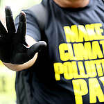 Climate impacted communities, civil society representatives, environmental activists, and Greenpeace thrust their black-tainted palms as they stand in protest outside the DENR (Department of Environment and Natural Resources) office along Visayas Avenue. The groups call for the government to make climate polluters accountable for extreme weather events like the southwest monsoon rain enhanced by Super Typhoon Carina, and the oil spill off Manila Bay following the recent sinking of two cargo ships in Limay, Bataan west of Manila. The protesters are demanding that the Marcos Jr. administration hold climate polluters accountable and make them pay for damages to ecosystems, community livelihoods, and health.