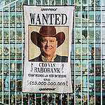 Greenpeace Netherlands activists protest with a western style “wanted” banner at the Zuidas, the Dutch financial district in Amsterdam. They hold the CEO of Rabobank accountable for causing 10.000.000.000 euro of damage due to deforestation in Brazil.