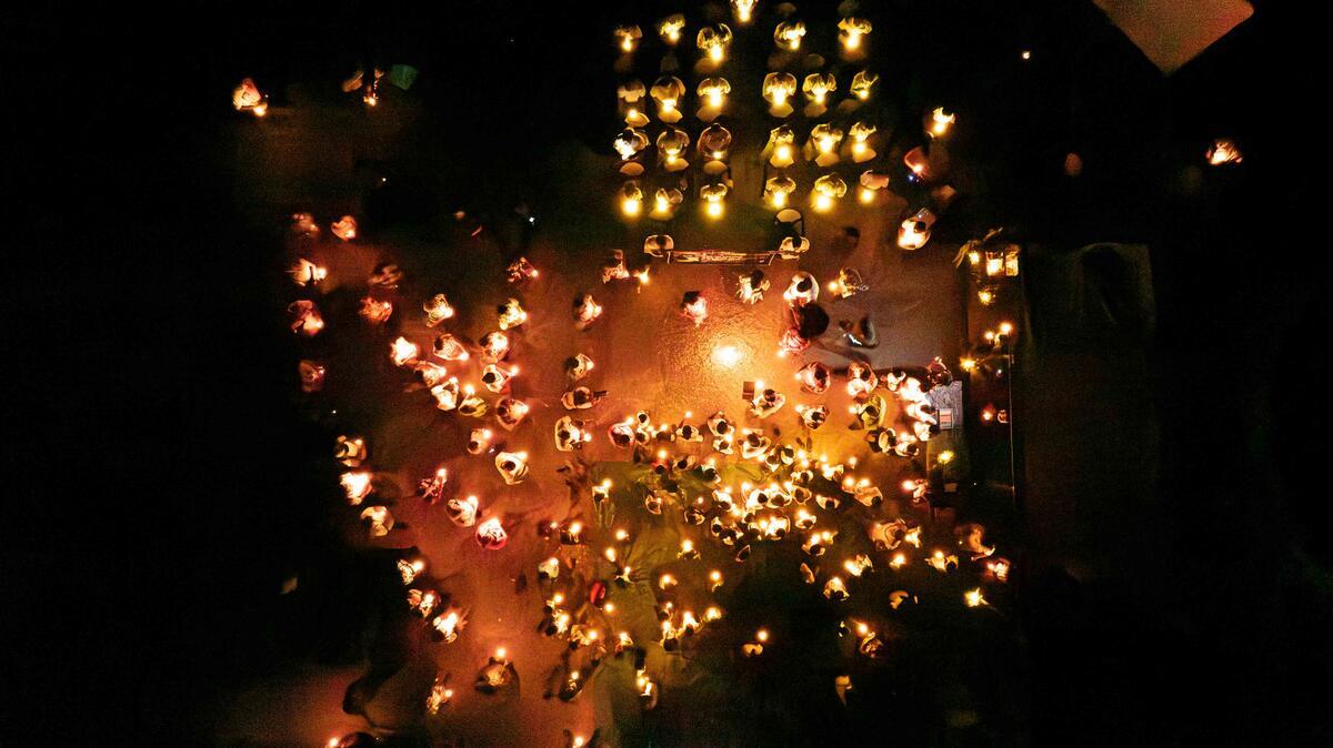 Aerial shots above candlelit Vigil, as community comes together for 40th Anniversary of Operation Exodus. © Greenpeace / Chewy C. Lin