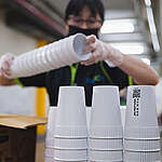 The Reusable Cup measure in Taiwan, driven by proactive engagement from advocacy groups working on reducing plastic use, involves the establishment of a borrowing and recycling cup system, where the public can borrow reusable cups to avoid single-use plastic waste.
In the picture: worker at the Blue Ocean Vision company, where cups are washed for reuse.