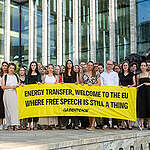 People gather outside the New Amsterdam Courthouse holding a banner reading "Energy Transfer, Welcome To The EU Where Free Speech Is Still A Thing" to mark the beginning of Greenpeace International's anti-SLAPP lawsuit against fossil fuel pipeline company Energy Transfer filed in Amsterdam, The Netherlands.