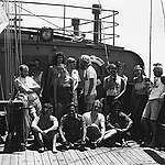 The 1985 'Rainbow Warrior' crew. 
Clockwise, starting from bottom left: Bene Hoffman, Second Mate, Germany, Davey Edwards, Chief Engineer, UK, Nathalie Thomas Mestre, Cook, Switzerland, Lloyd Anderson, Radio Operator, Fernando Pereira, Hanne Sorensen, Bunny McDiarmid, Deckhand, New Zealand, Peter Willcox, Skipper, USA, Martini Gotje, First Mate, The Netherlands, in front of Martini, girlfriend of crew member Andy Biederman, Doctor, Switzerland (not present in the group shot), Hanne Sorensen, Second Engineer, Denmark,  New Zealand journalist David Robie, sitting from left: Grace O'Sullivan, Deckhand, Ireland; Marshallese traveller; Henk Haazen, Third Engineer, The Netherlands; Marshallese traveller.