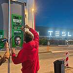 Posters show the portrait of Donald Trump and Elon Musk and the text "Time to Resist" at Tesla dealership in Amsterdam.

During his first 100 days in office, Donald Trump has set about dismantling environmental and climate protections and democratic principles, and attacking those who speak up against the corporate profits of and overreach of his billionaire friends.
Billionaires and corporations are taking control of our rights and freedoms.
Using their vast fortunes, they lobby to weaken regulations meant to protect people and the planet, fund candidates who serve their interests, and gain control of the media to shape the stories we hear.
But these billionaires underestimate our power to resist. Together we’ve formed unions to challenge factory owners, fought oppressive regimes to win our rights to vote and protected precious ecosystems from multinational corporations. We’ve fought and won before – so we can fight and win again.